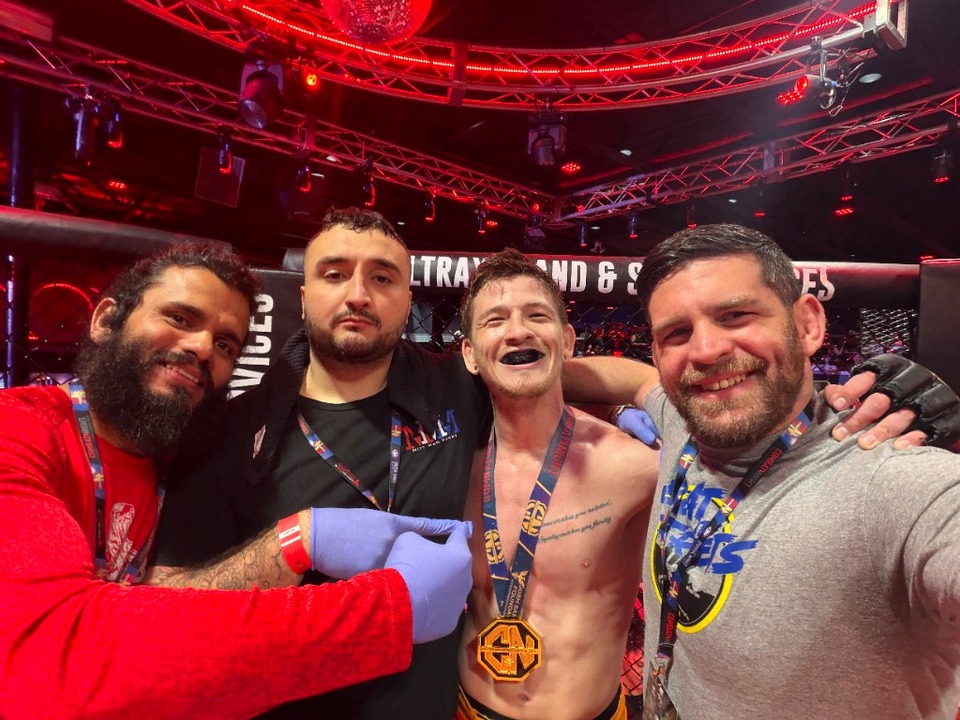 Combat Night victory celebration in the octagon with gold medal